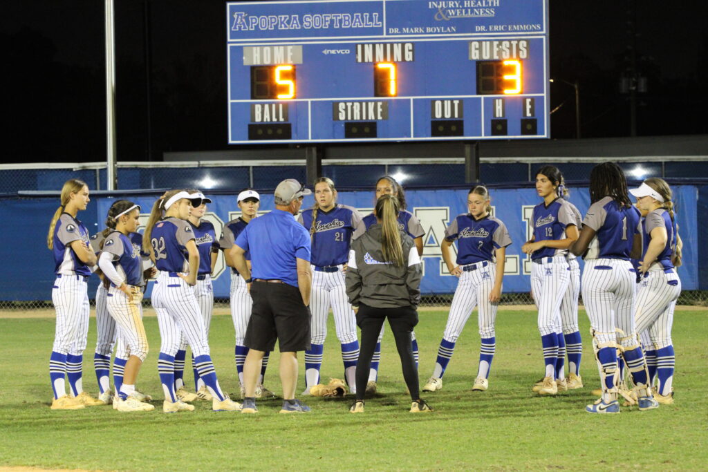 Apopka softball huddles in the outfield after their 5-3 victory over Horizon