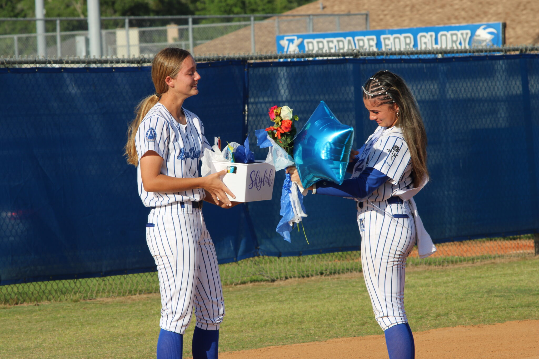 Ava Gonzalez hands Shylah Pino her senior gift basket