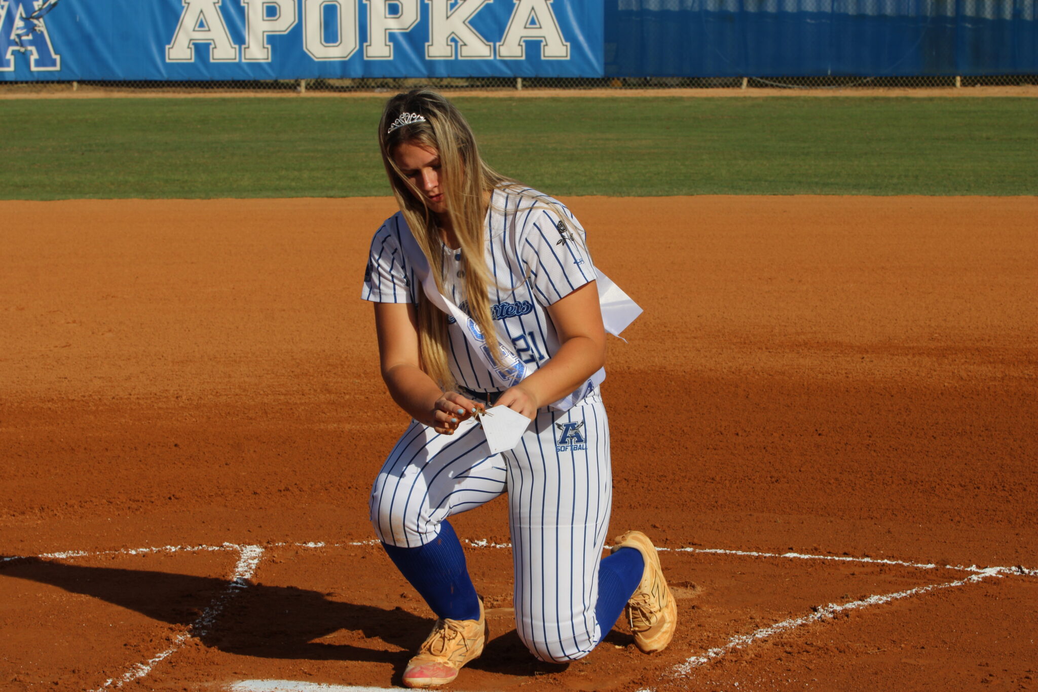 Ava Millspaugh collects dirt in memorial of her time pitching in that circle