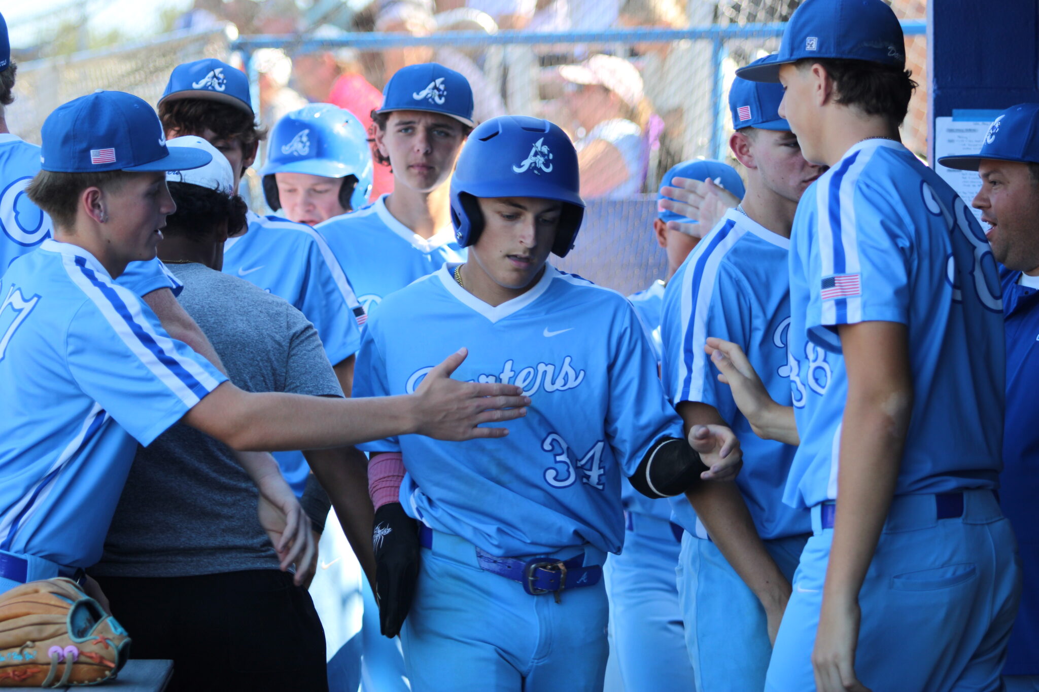 Blue Darter dugout welcomes in Aiden Rieli after scoring their second run of the game
