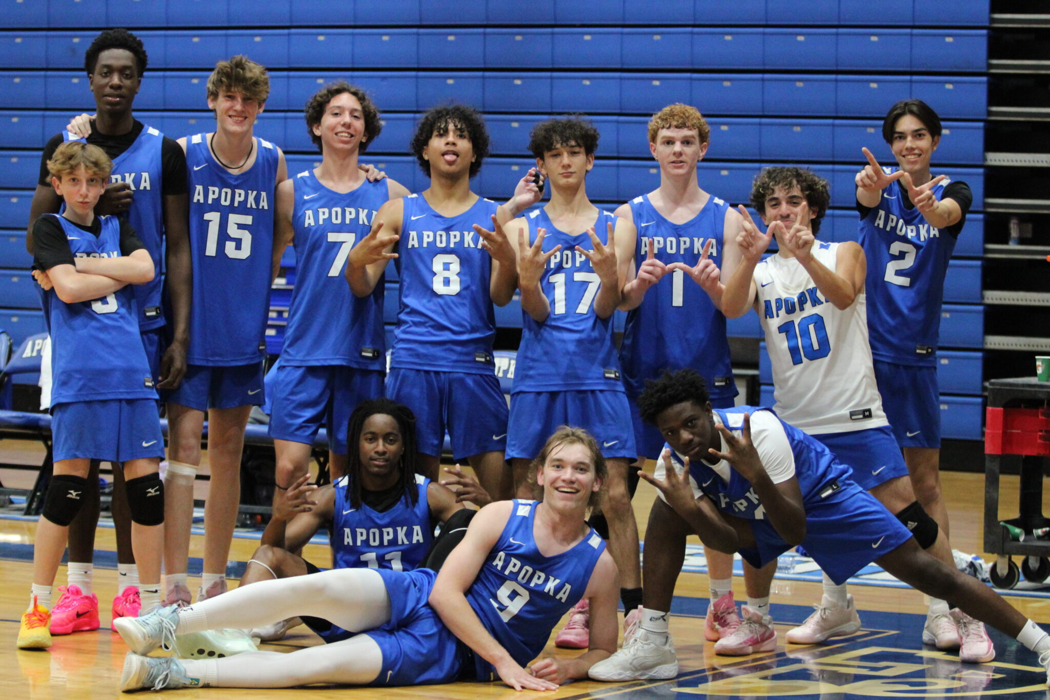 Blue Darters pose after senior night sweep against Olympia