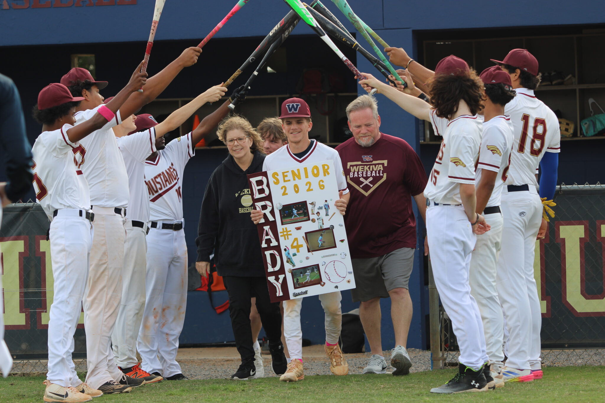 Brady Reinert walks out with his family for senior night