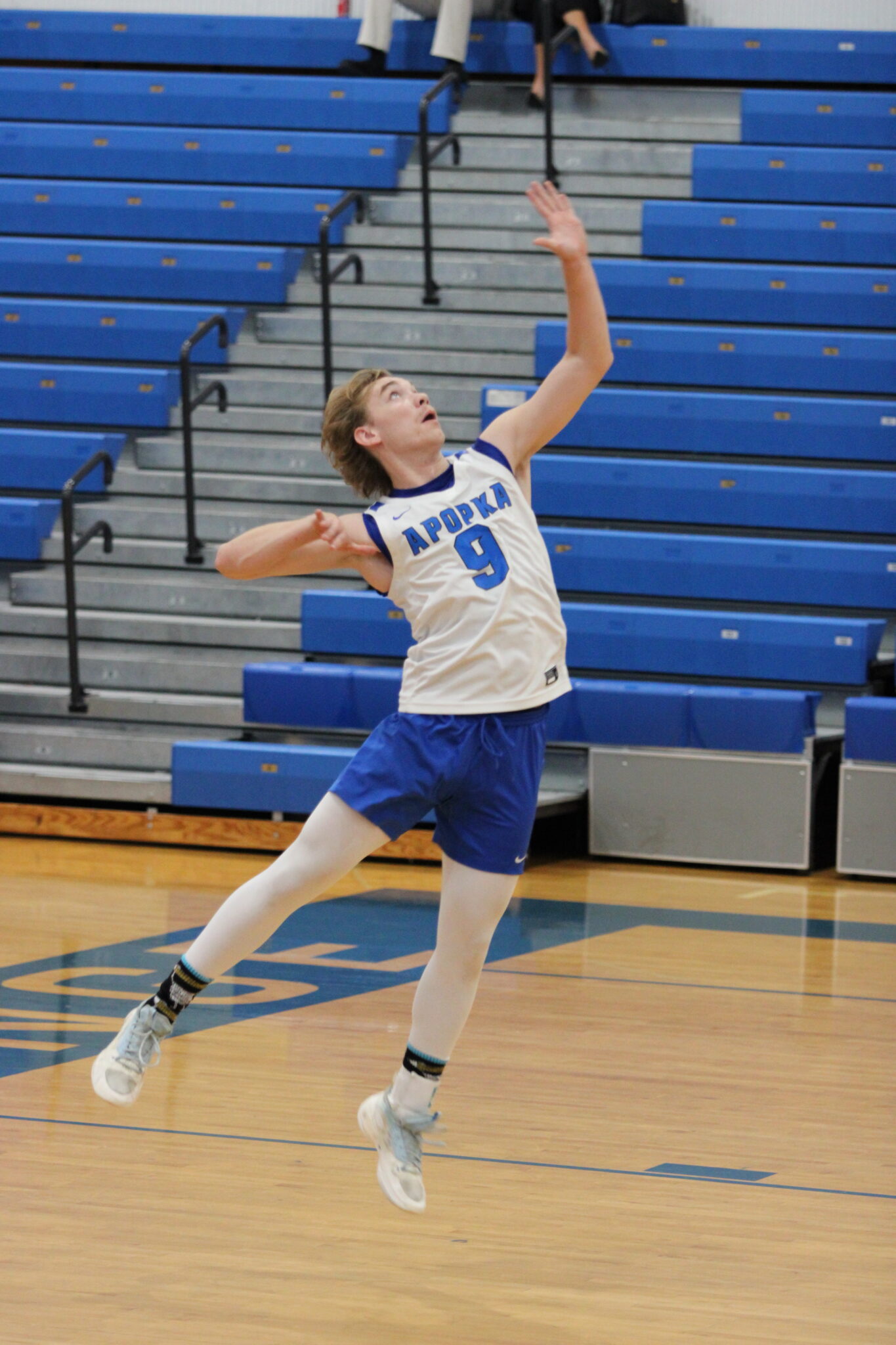 Caden McGatha whips over his first serve of the district championship game