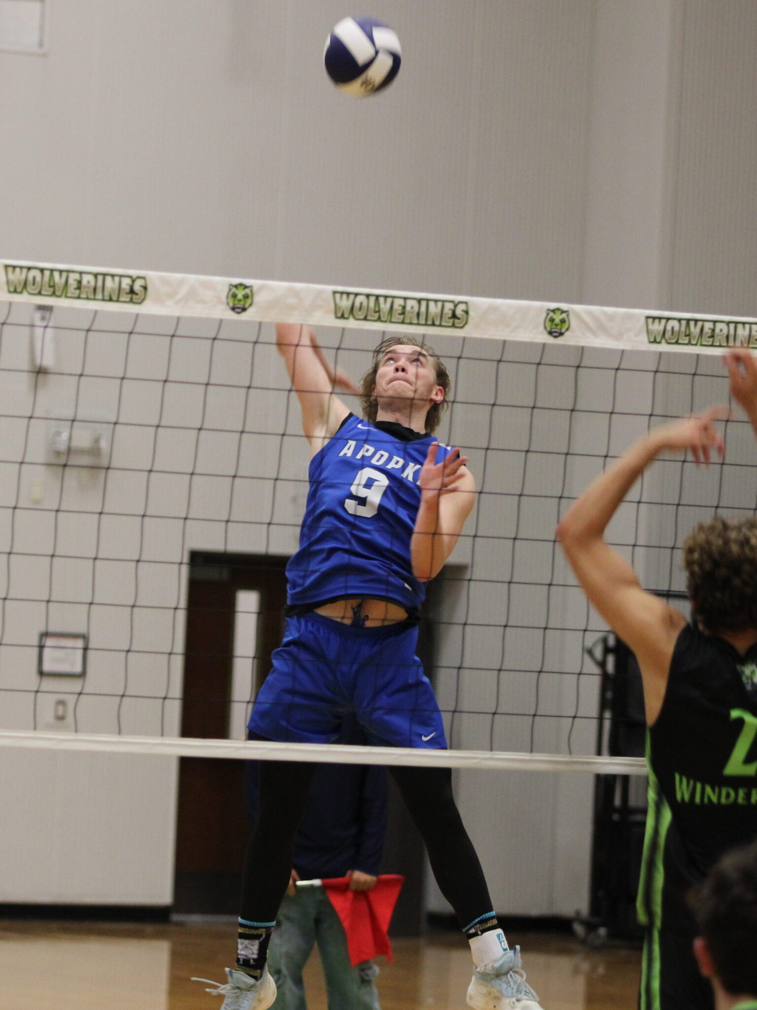 Caden McGatha winds back to rip a shot over the net