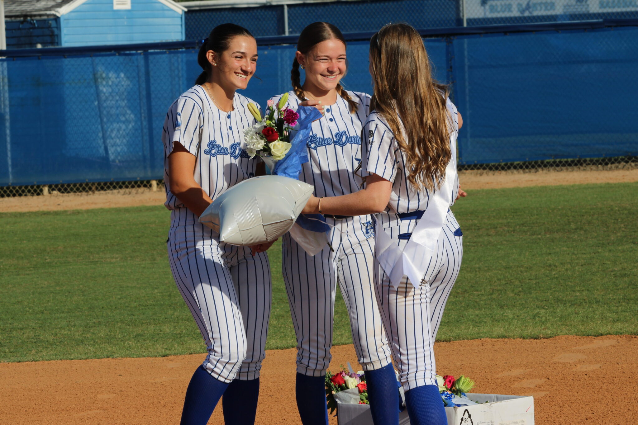 Callie Sowers and Braylyn Pirillo greet Haylee Thames at second base
