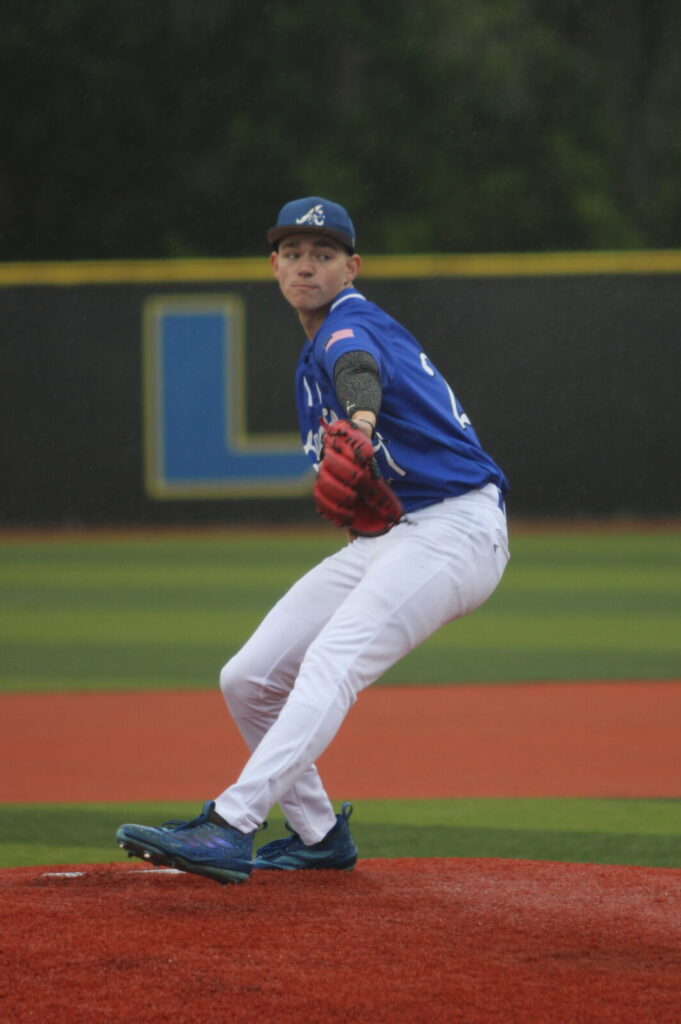 Camron Pennock winds back to blister a pitch past the batter