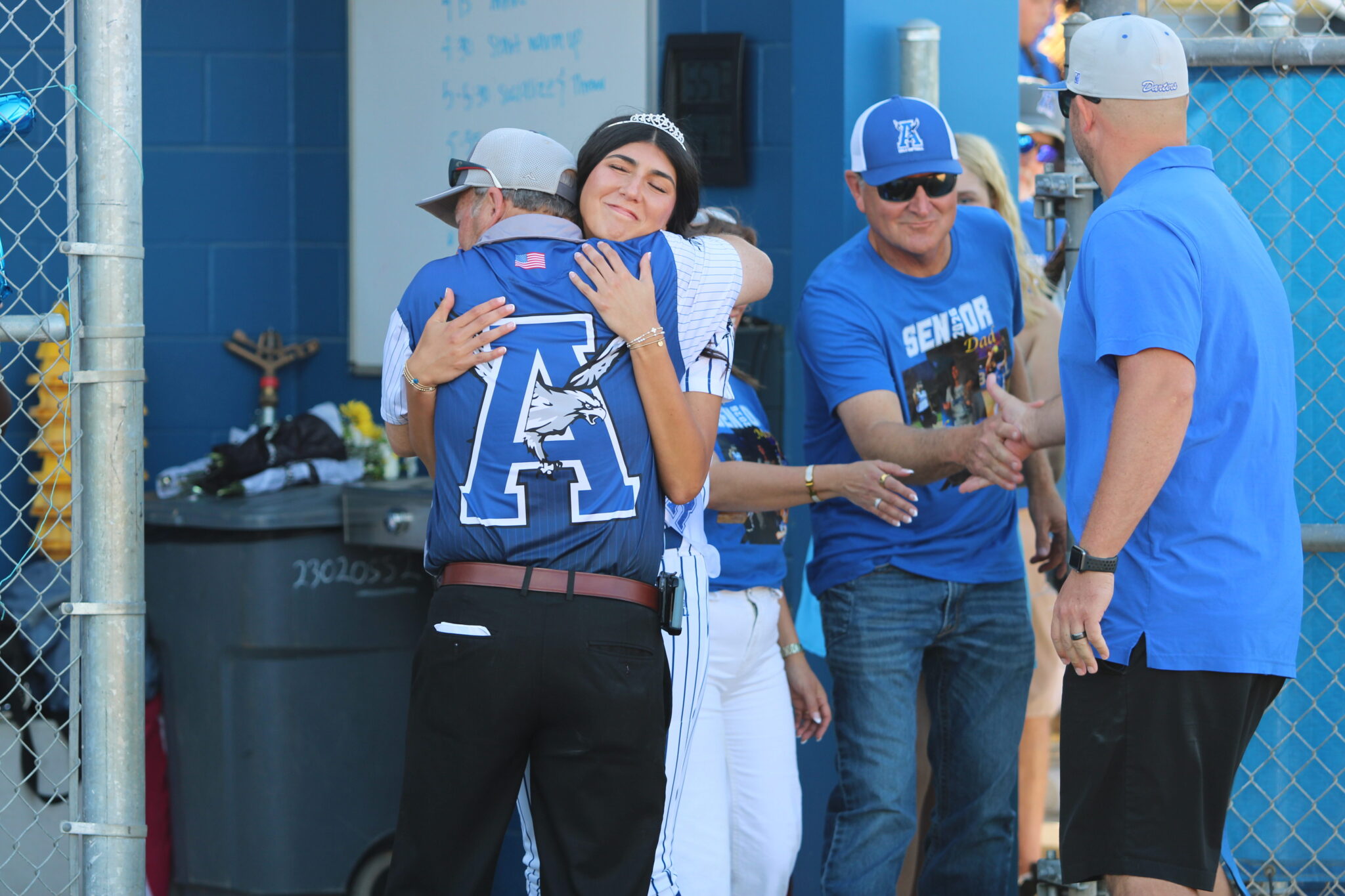 Coach Mike MacWithey greets Mia Aeschilman with a hug on senior night