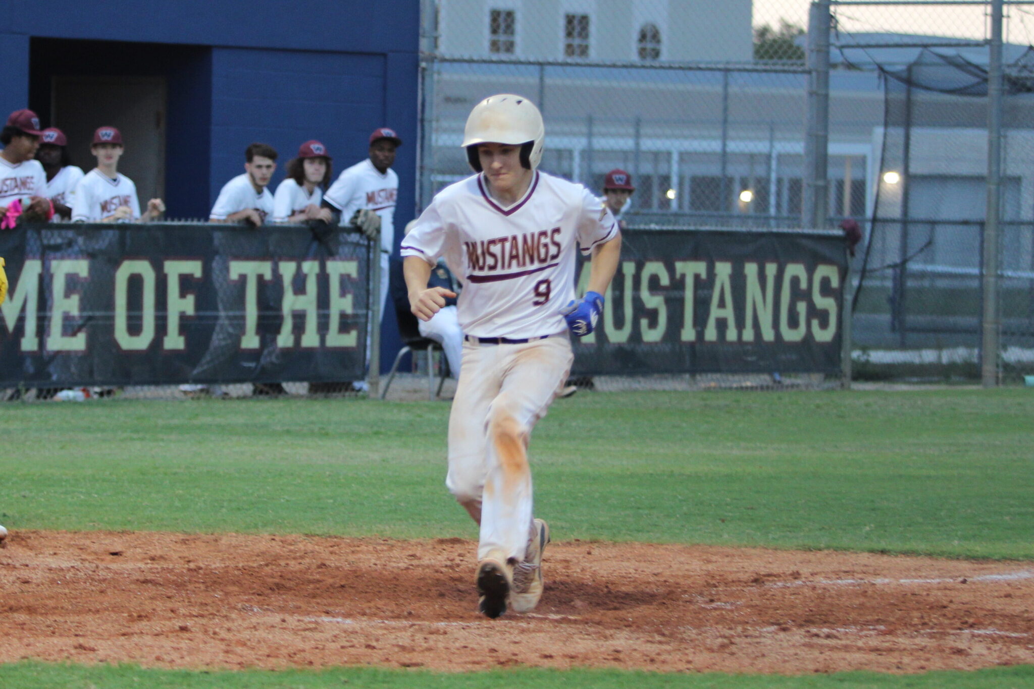 Cody Bowen crosses home plate against Circle Christian