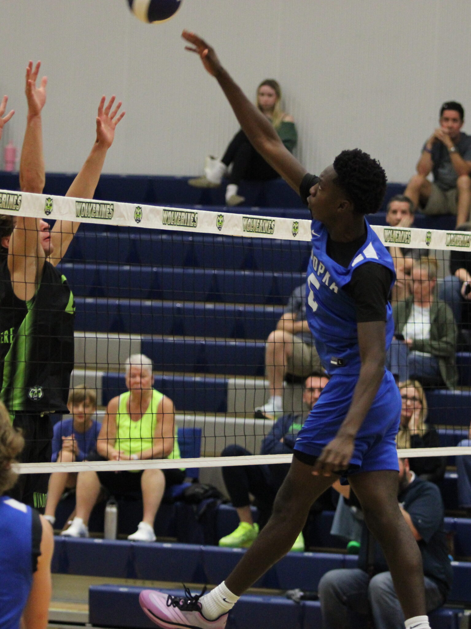 Giovanni Lubin rises high above the net to hit one over the blocking hands