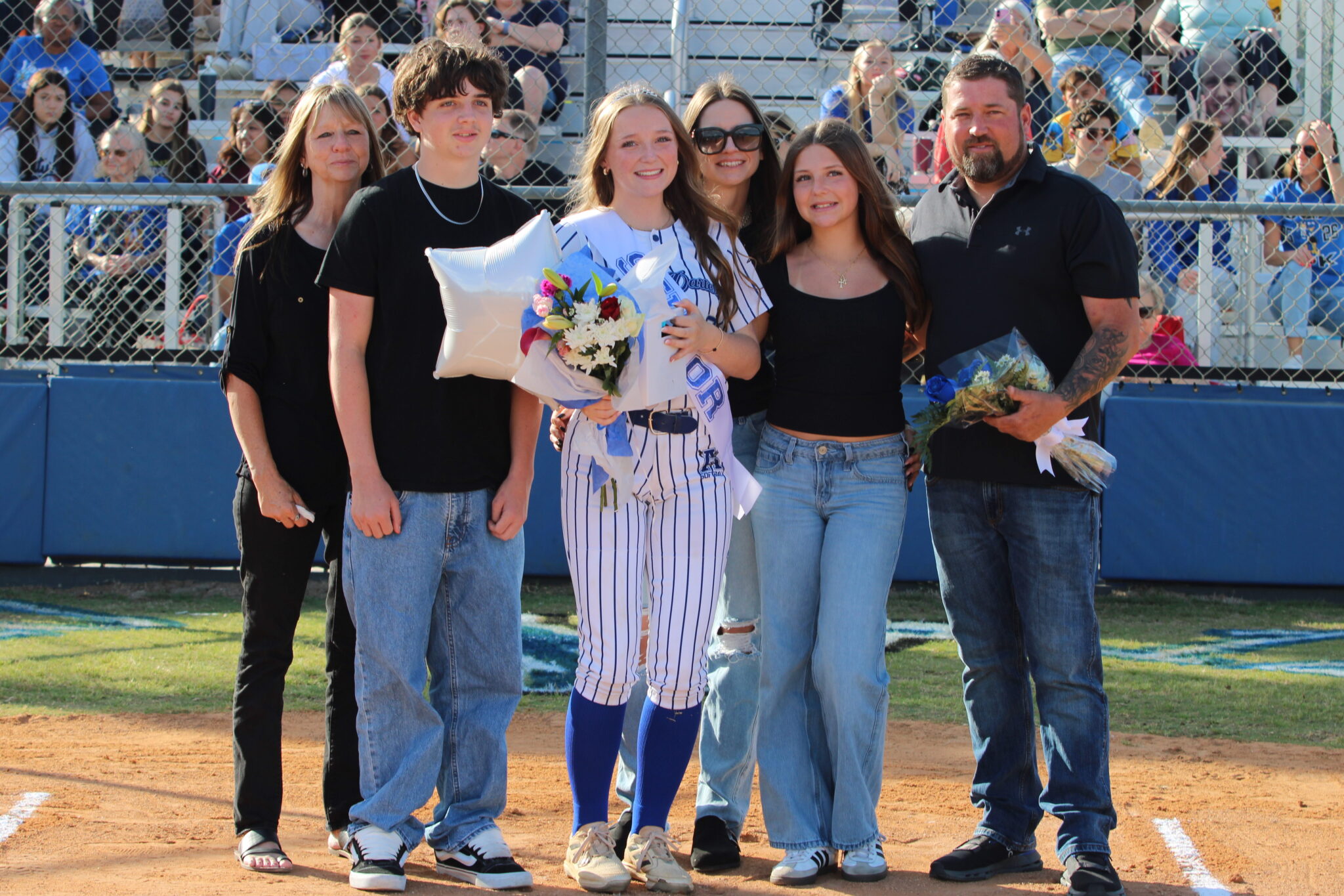 Haylee Thames poses with her family on senior night