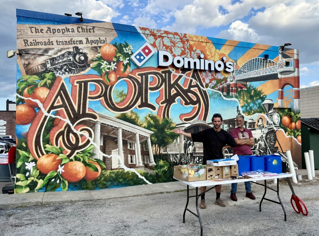 Ben Keller (left) and Luis Rivera (right) speak at the mural's unveiling Friday night.