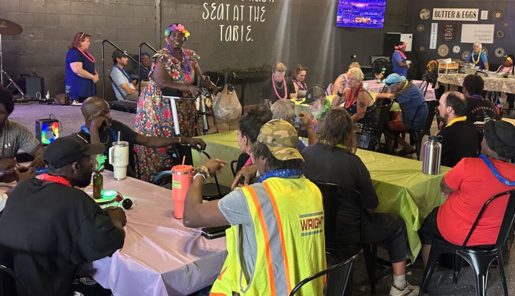 Virginia Street, Compassion in Apopka founder, addresses the people gathered for a monthly dinner this past Sunday hosted by her nonprofit at Just Like Momma’s Restaurant, where volunteers serve meals to people experiencing homelessness and others in need.