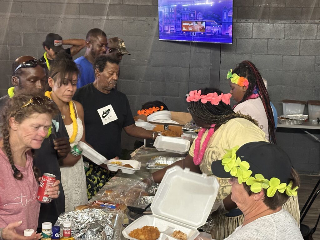 Volunteers serve food during a monthly Compassion in Apopka dinner at Just Like Momma’s Restaurant, an outreach effort providing meals and support to residents in need.   