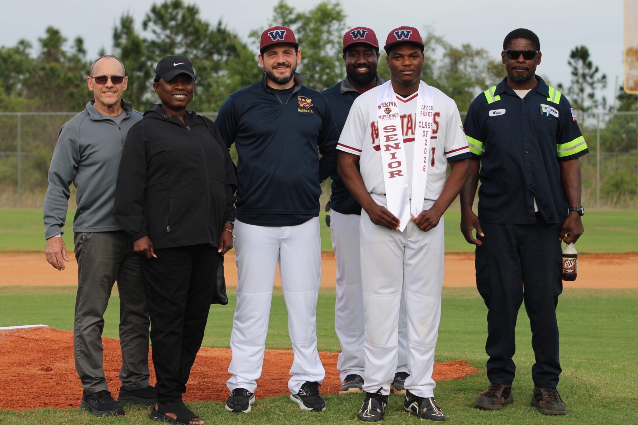 Ja'Codi Parker poses with his family and coaches for senior night