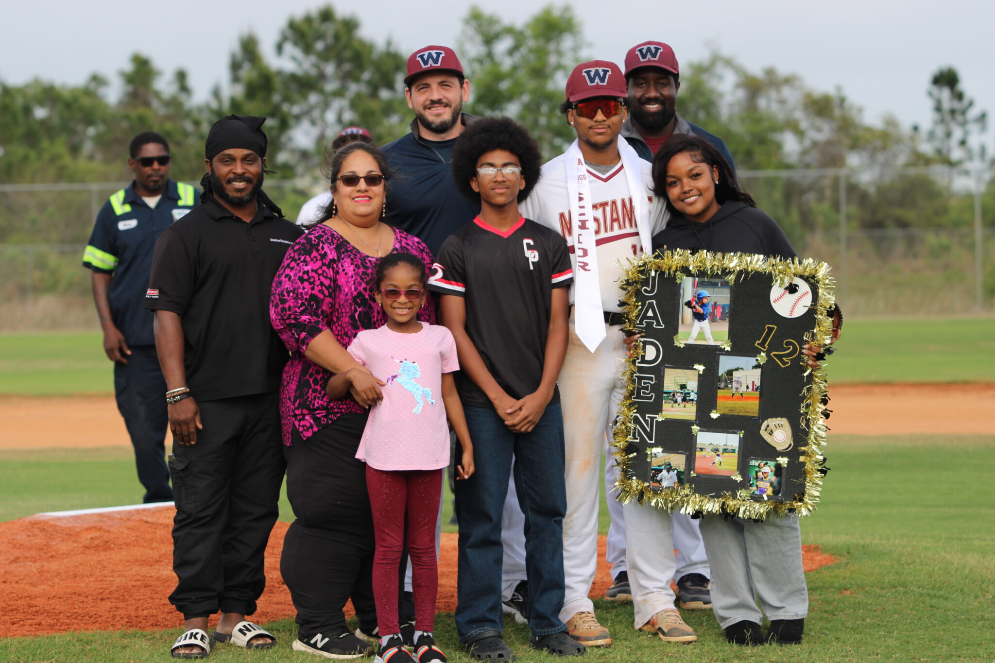 Jaden Graham poses with his family and coaches for senior night