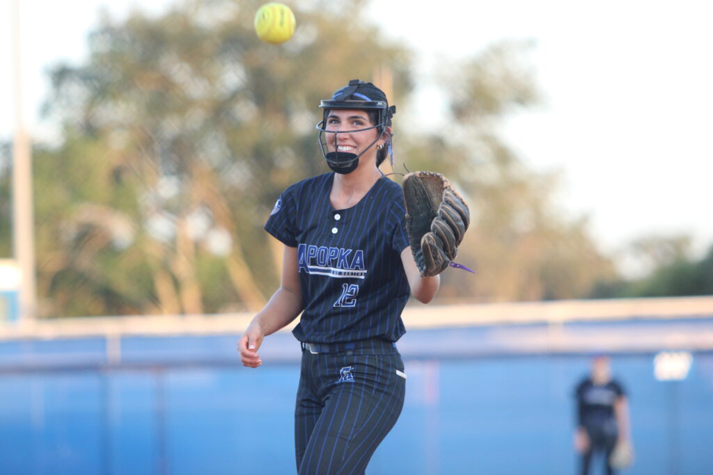 Mia Aeschilman has a laugh after her accidental wild pitch