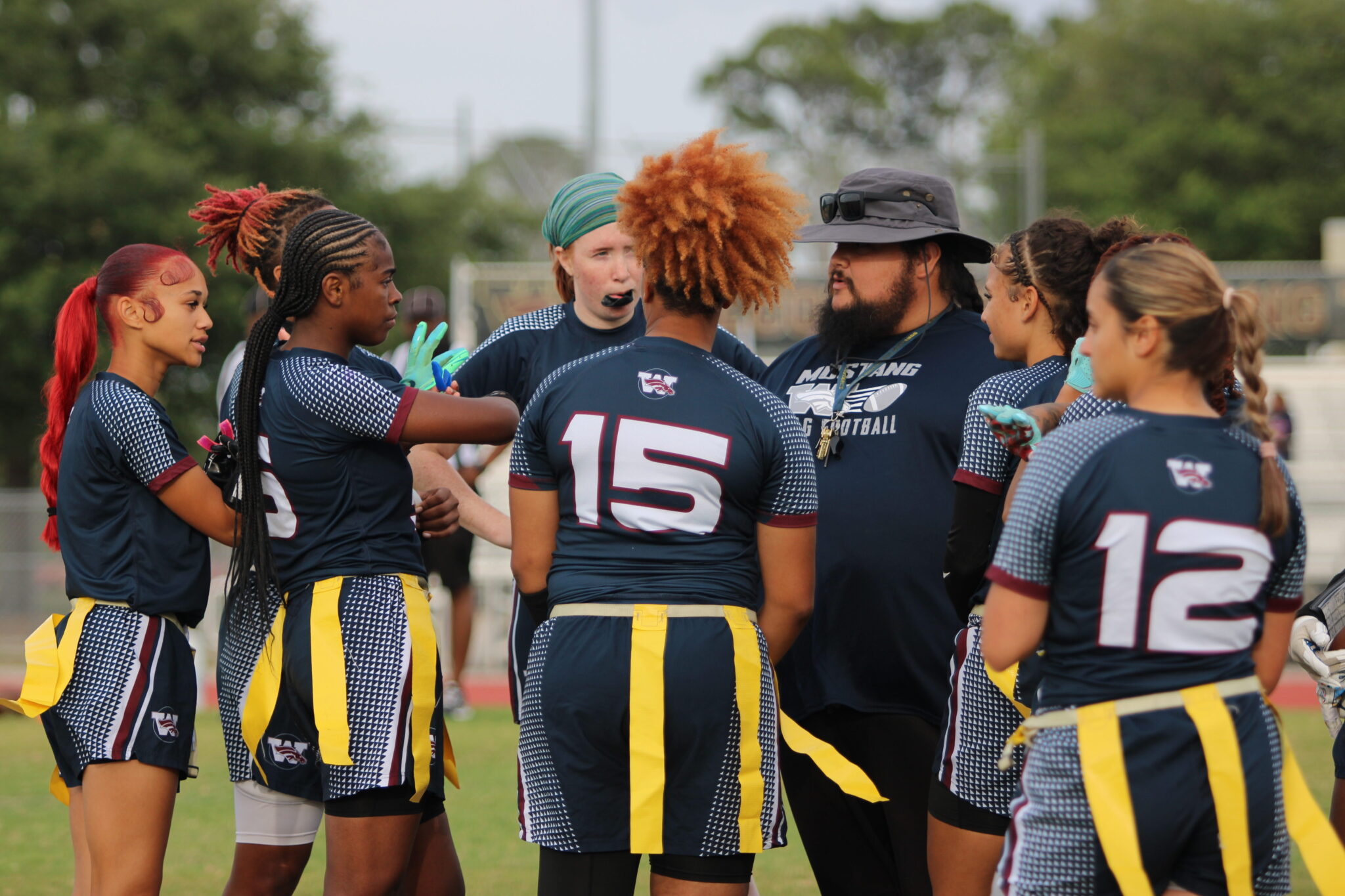 Mustangs huddle for halftime and. make adjustments to their gameplan for the second half