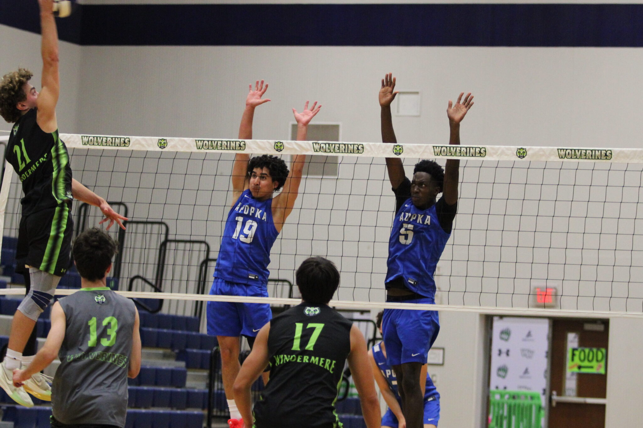 Noel Nieves (19) and Giovanni Lubin (5) rise up at the net together in attempt to stop the Windermere hit