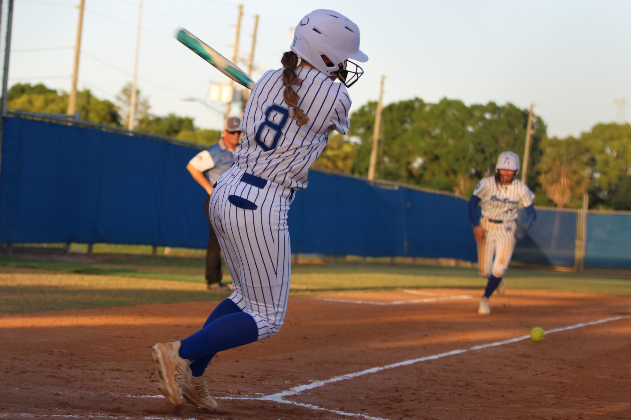 Riley Ford hits a ball up the third base line to score Shylah Pino from third