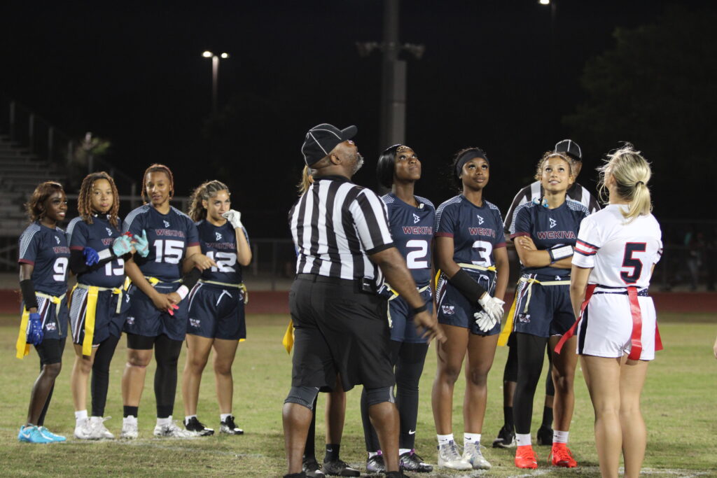 Senior captains watch the coin toss flip through the air on their senior night