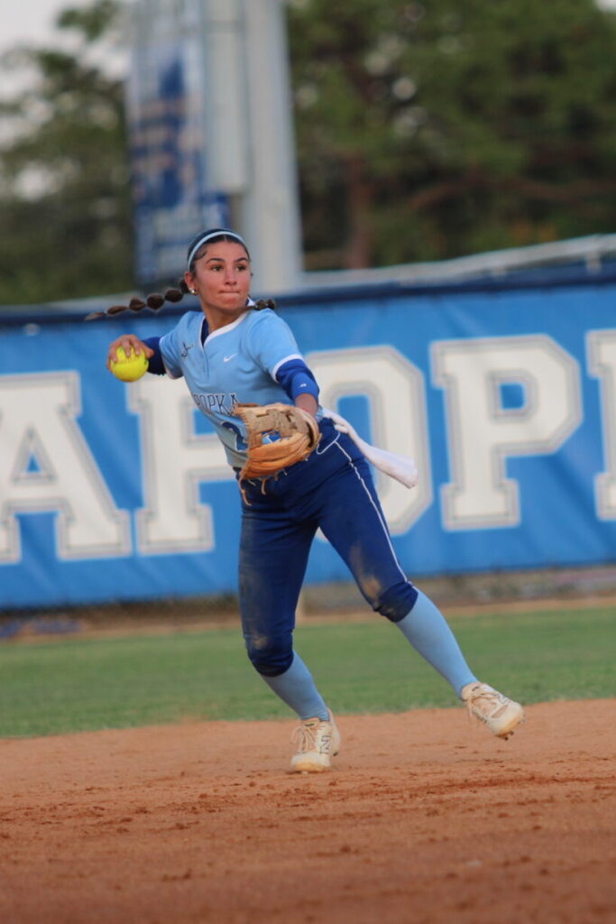 Shylah Pino fields a ground ball at shortstop and guns out the runner at first base