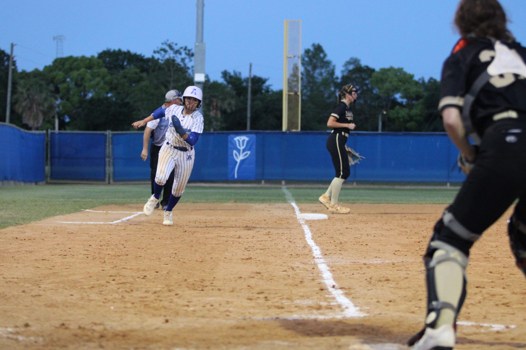 Shylah Pino rounds third off Taylor Smiths hit into the outfield and turns her attention to home plate