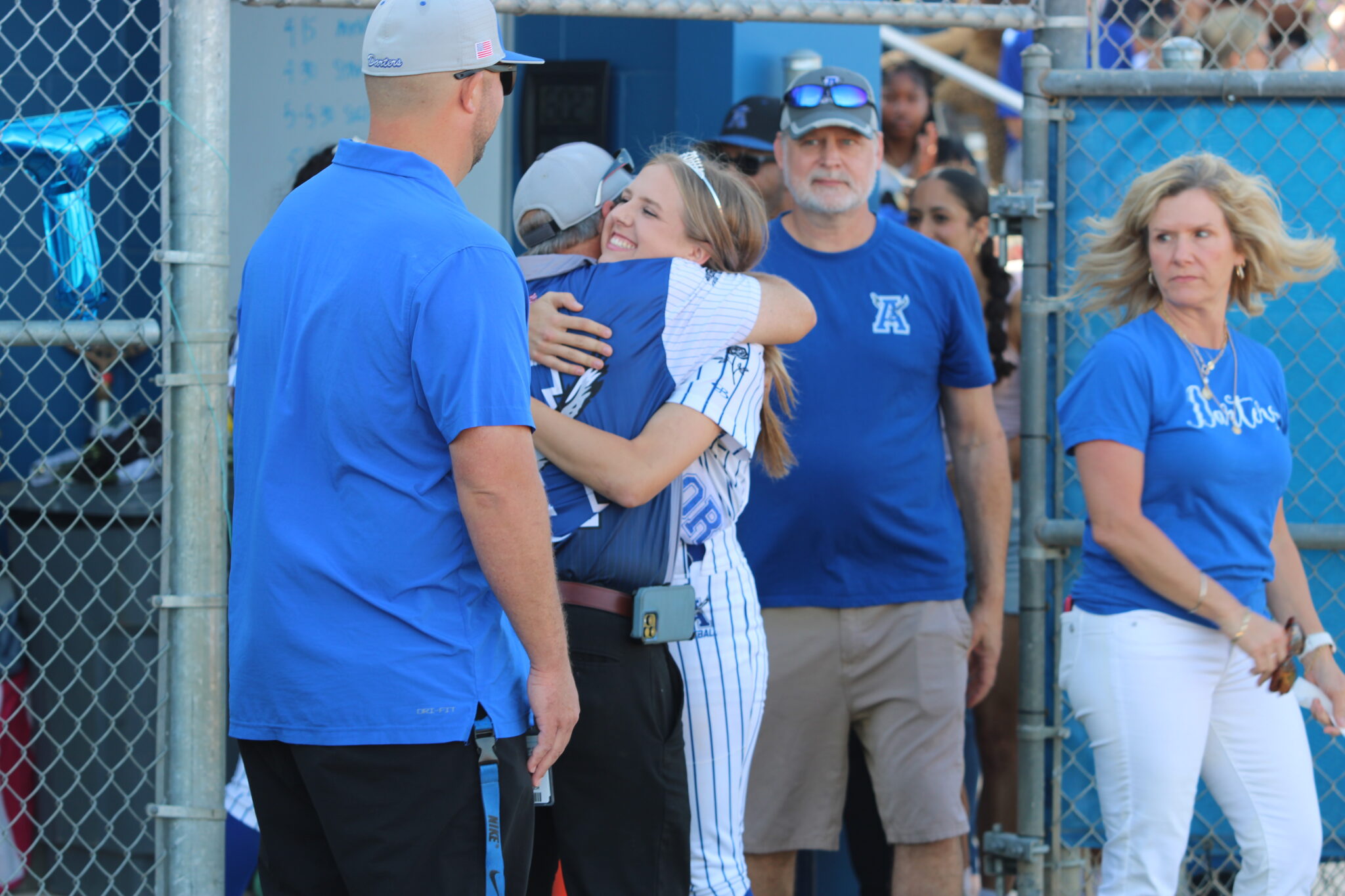 Sydney Bartkin walks out for senior night and shares a hug with Coach Mike MacWithey