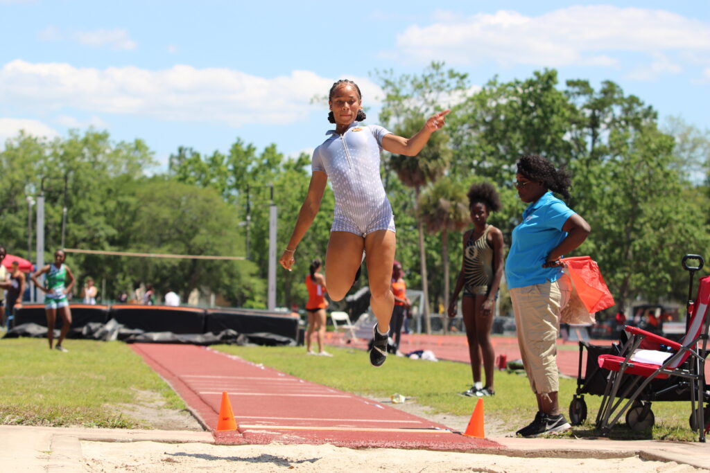 Tamea Foster glides through the air and places third in the girls long jump