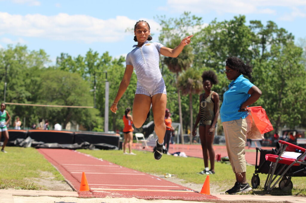 Tamea Foster glides through the air and places third in the girls long jump