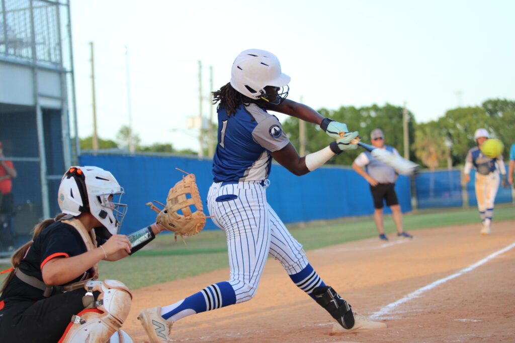 Taylor Smith blisters a ball into the outfield to score Shylah Pino