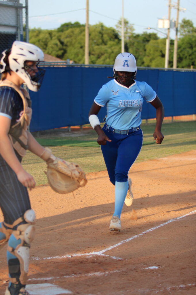 Taylor Smith crosses home plate after Ava Gonzalez sacrifice bunt in the district championship
