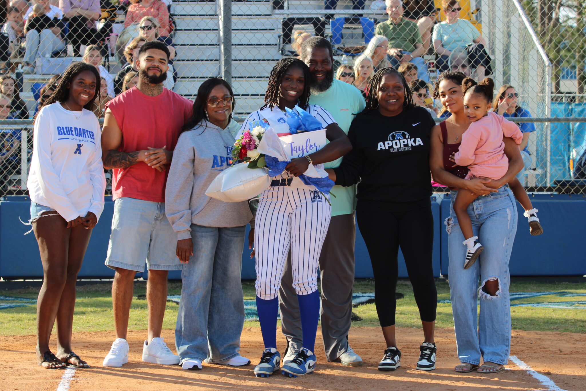 Taylor Smith poses with her family on senior night