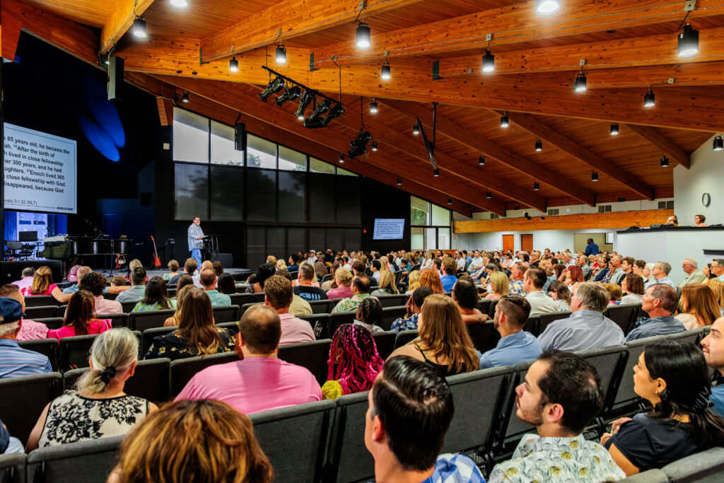 The congregation listens in at Renewal's new location.