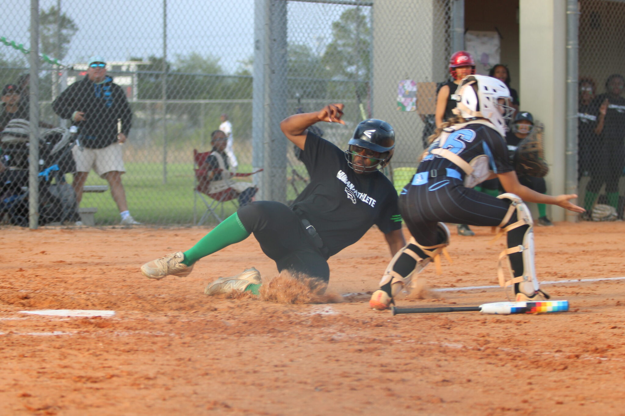 Ti'Riyah Williams slides safely past the catcher