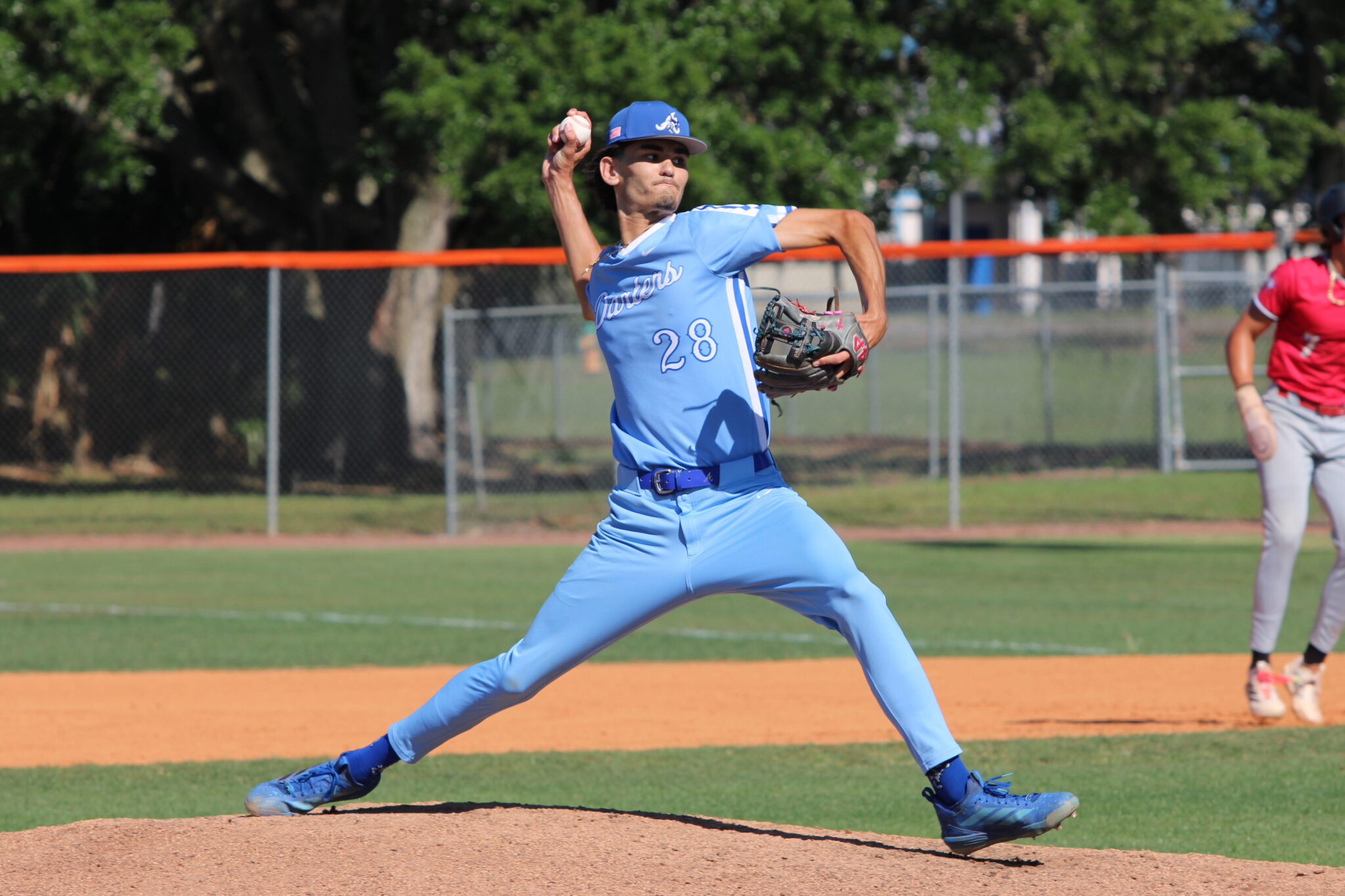 Tyler Spaid pitching from the stretch in the district semifinal against Lake Mary