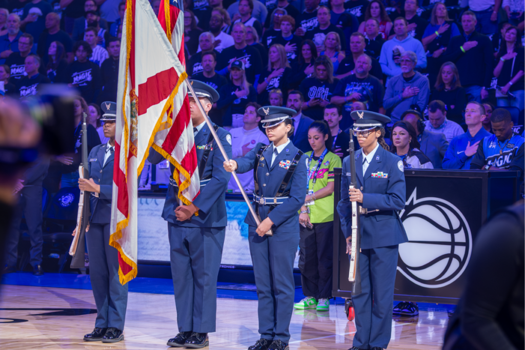 SrA Pacience Powell, Cadet 2nd LT William Warren, Major Emily Garcia, and Major Tarin Griffith stand at mid court presenting the nations colors during the National Anthem of Game 3 of the playoffs, Magic vs Pistons in the Kia Center