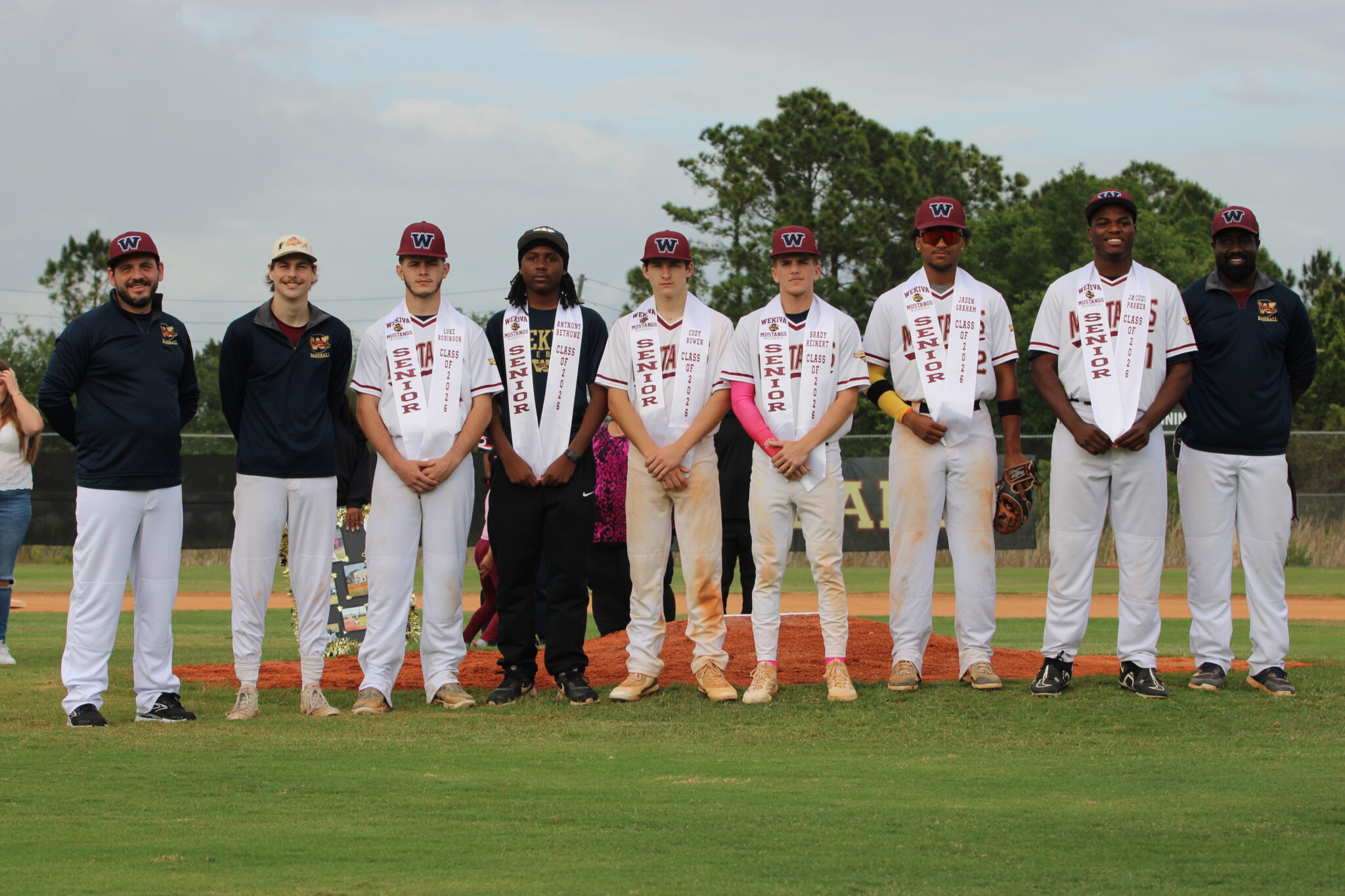 Wekiva Mustang seniors gather with their coaches before their senior night game against Circle Christian
