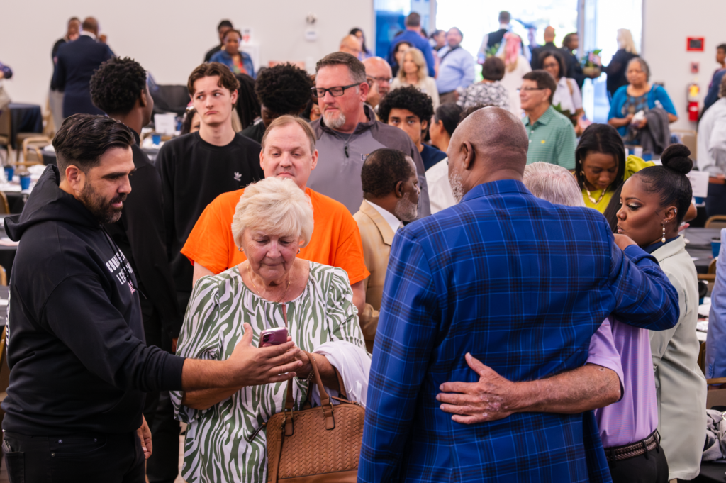 Apopka Mayor's Prayer Breakfast guests meet with Nick Anderson before the ceremony starts.
