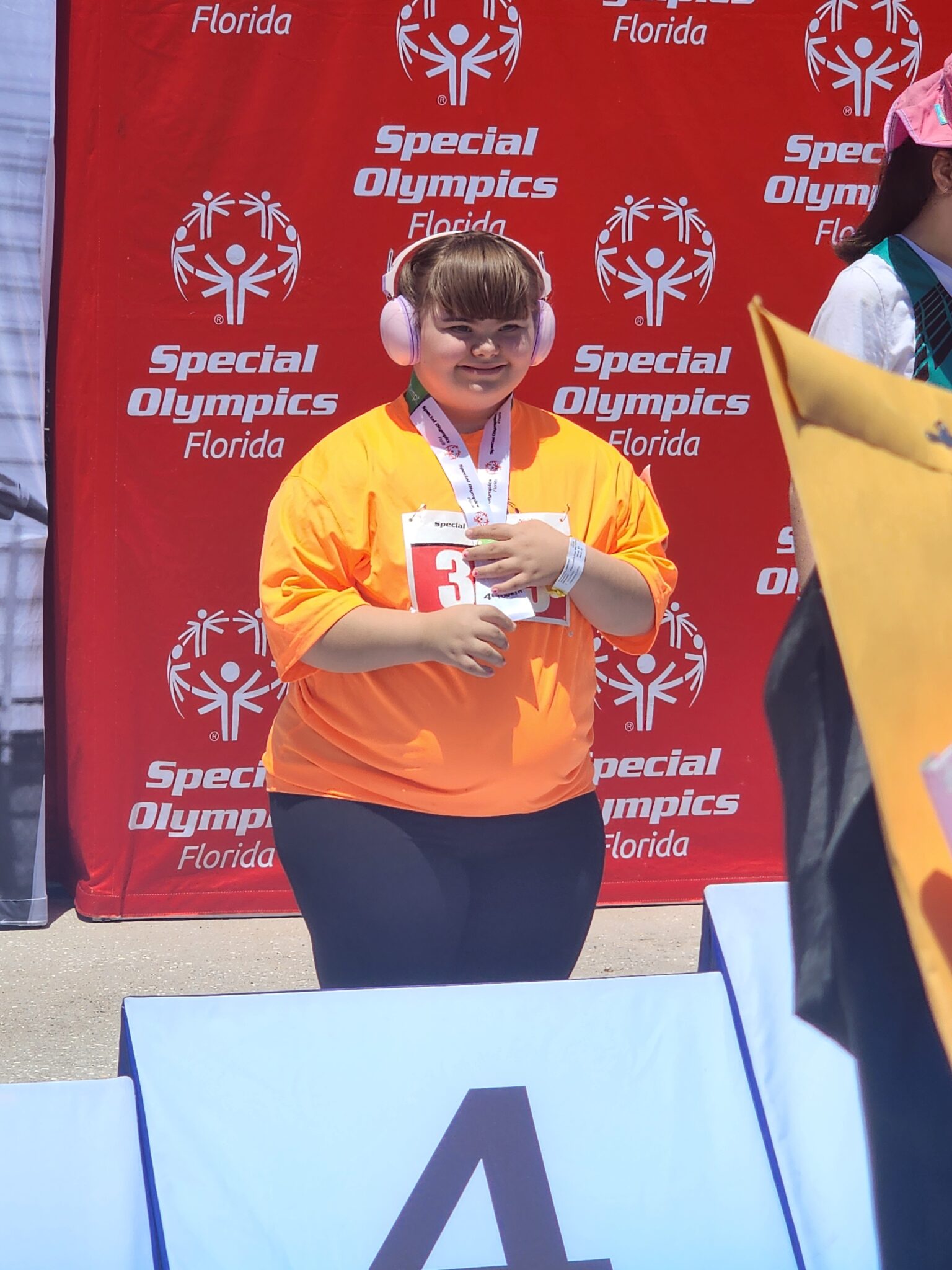 Jazzmin Gonzalez poses with her medals at the Florida Special Olympics
