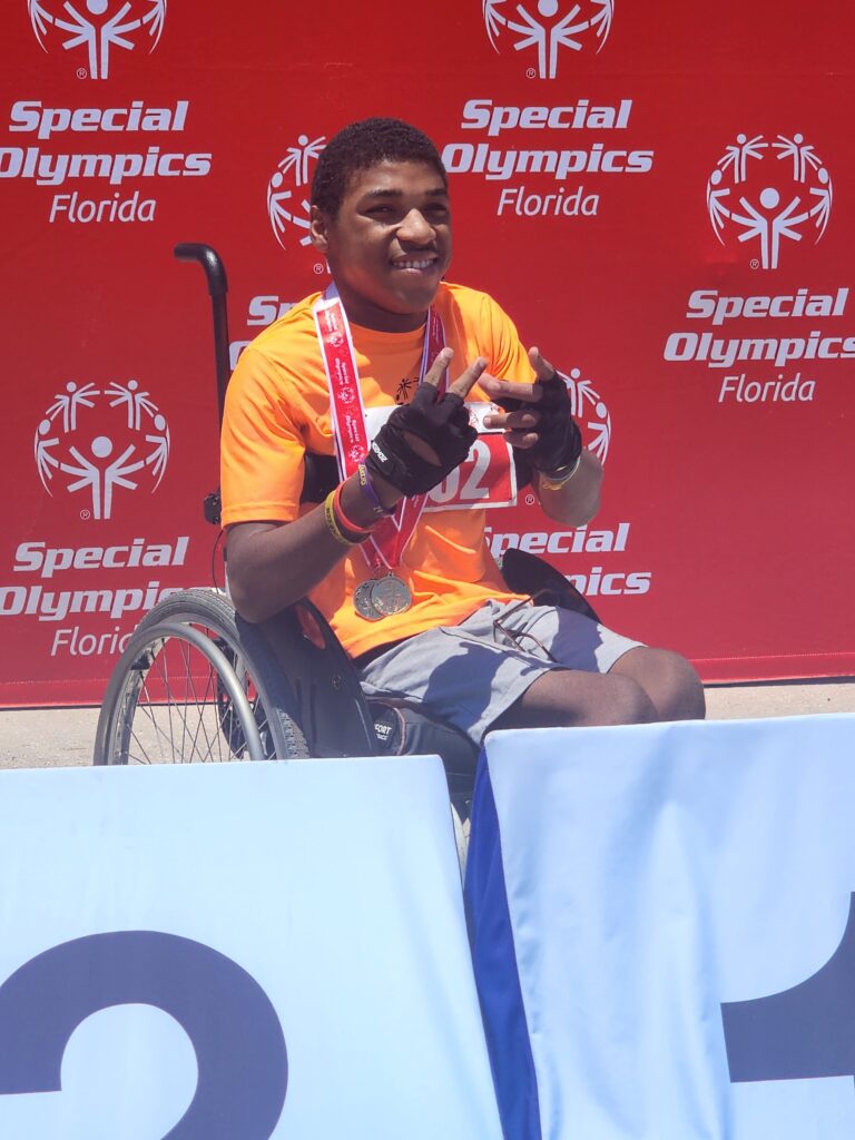 Maleek Brooks poses with his medals at the Florida Special Olympics