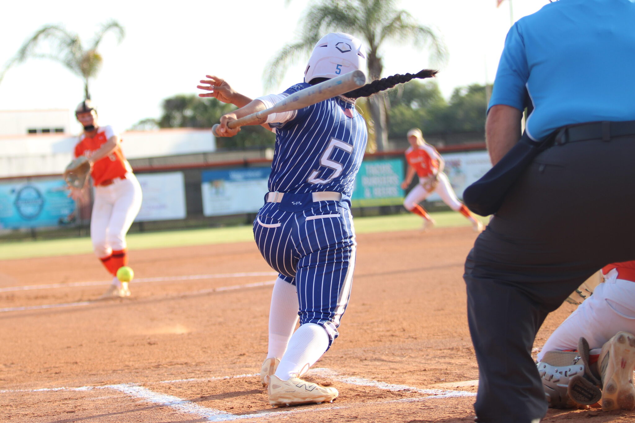 Alicia Lopez rips a ground ball back at and past the pitcher's glove