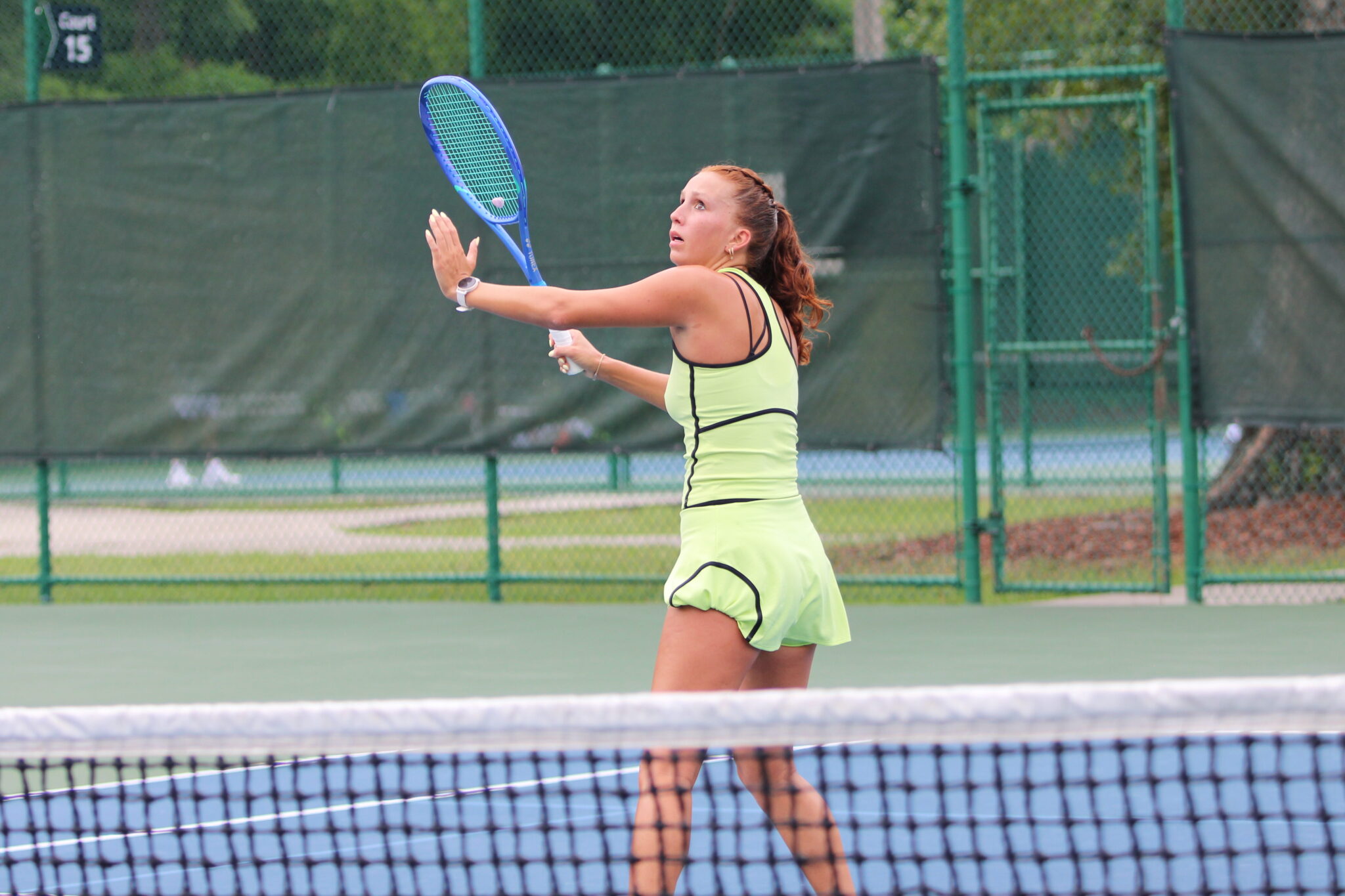 Alyssa Novoa awaits a volley at the net to smash