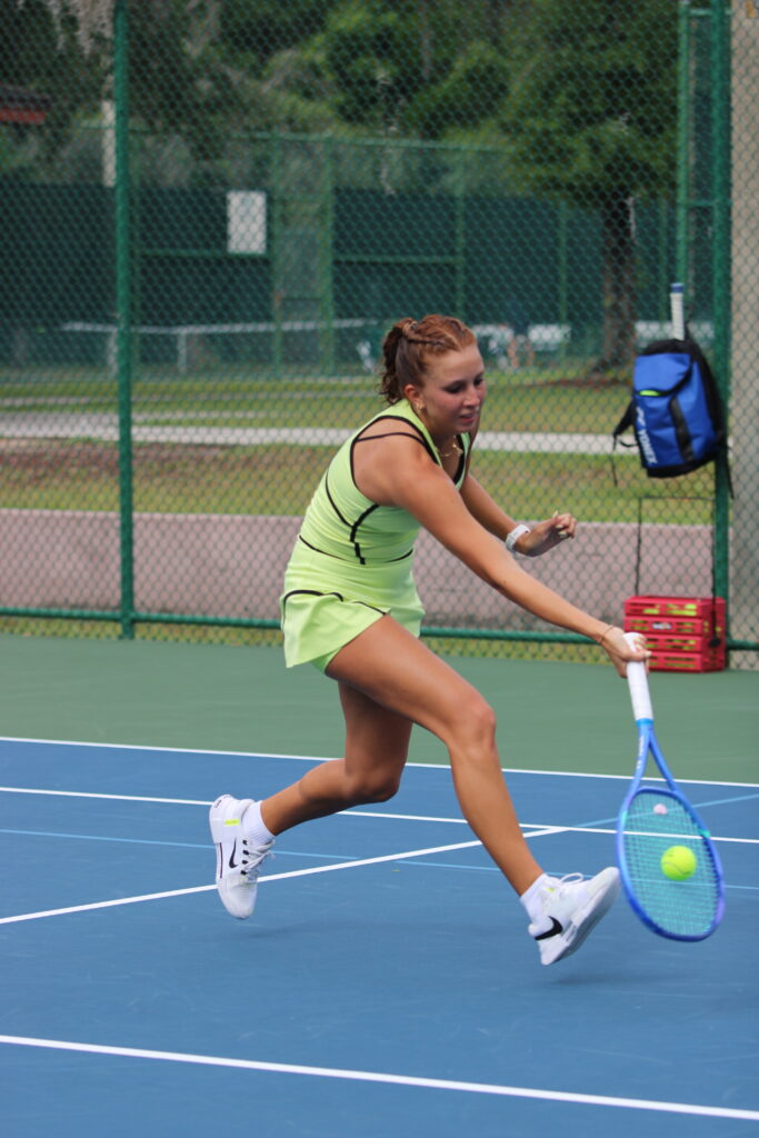 Alyssa Novoa digs out a dropshot at the net