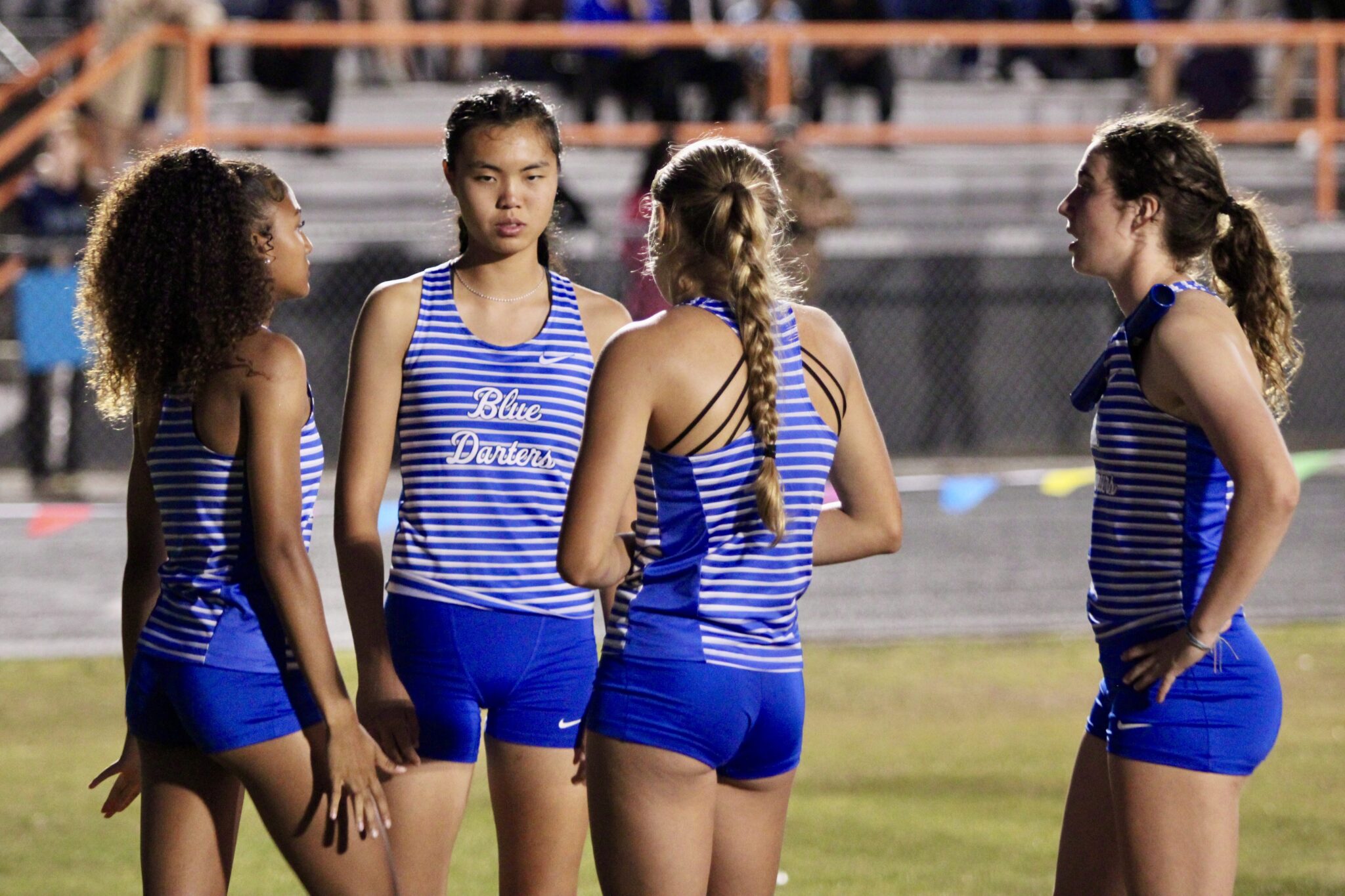 Blue Darters 4x400 girls relay team prepare for their regional race.
