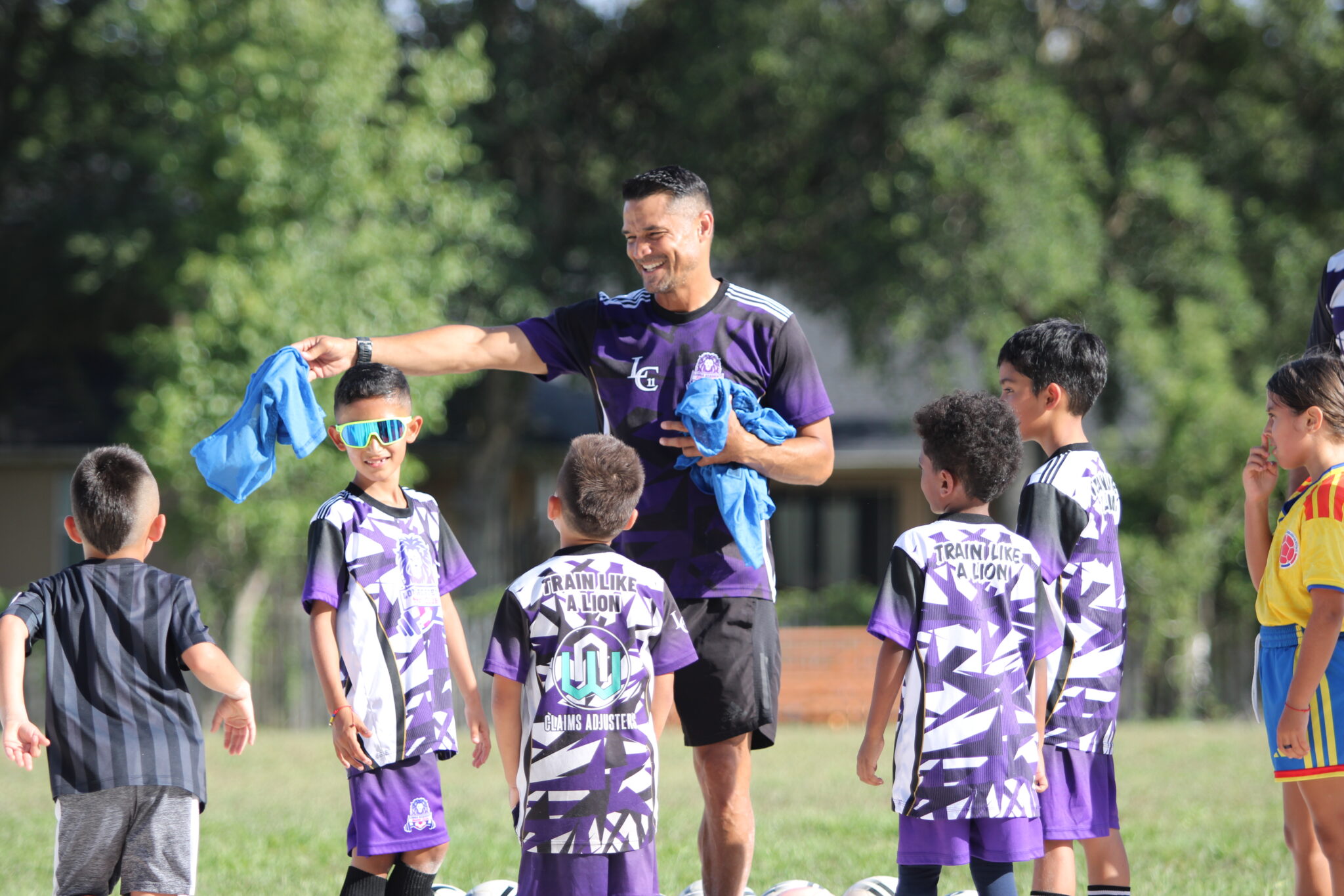 Carlos Longa hands out pinnie jerseys to prepare for the scrimmage drill.