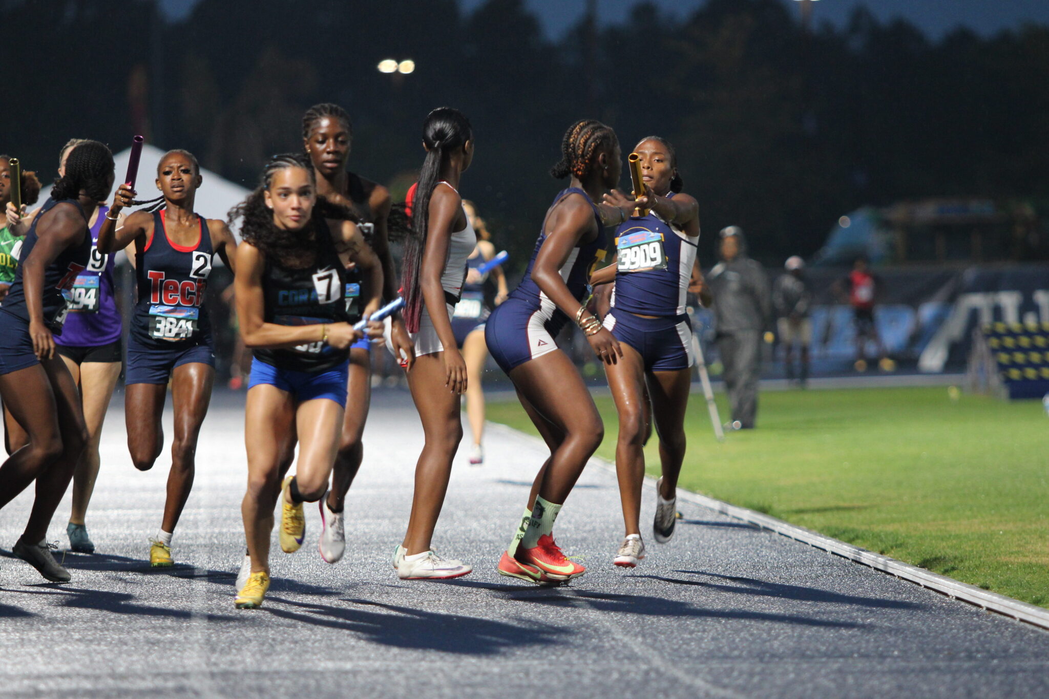 Cebreeya Hicks passes the baton to Akira Wise for the final leg of the girls 4x400 relay.
