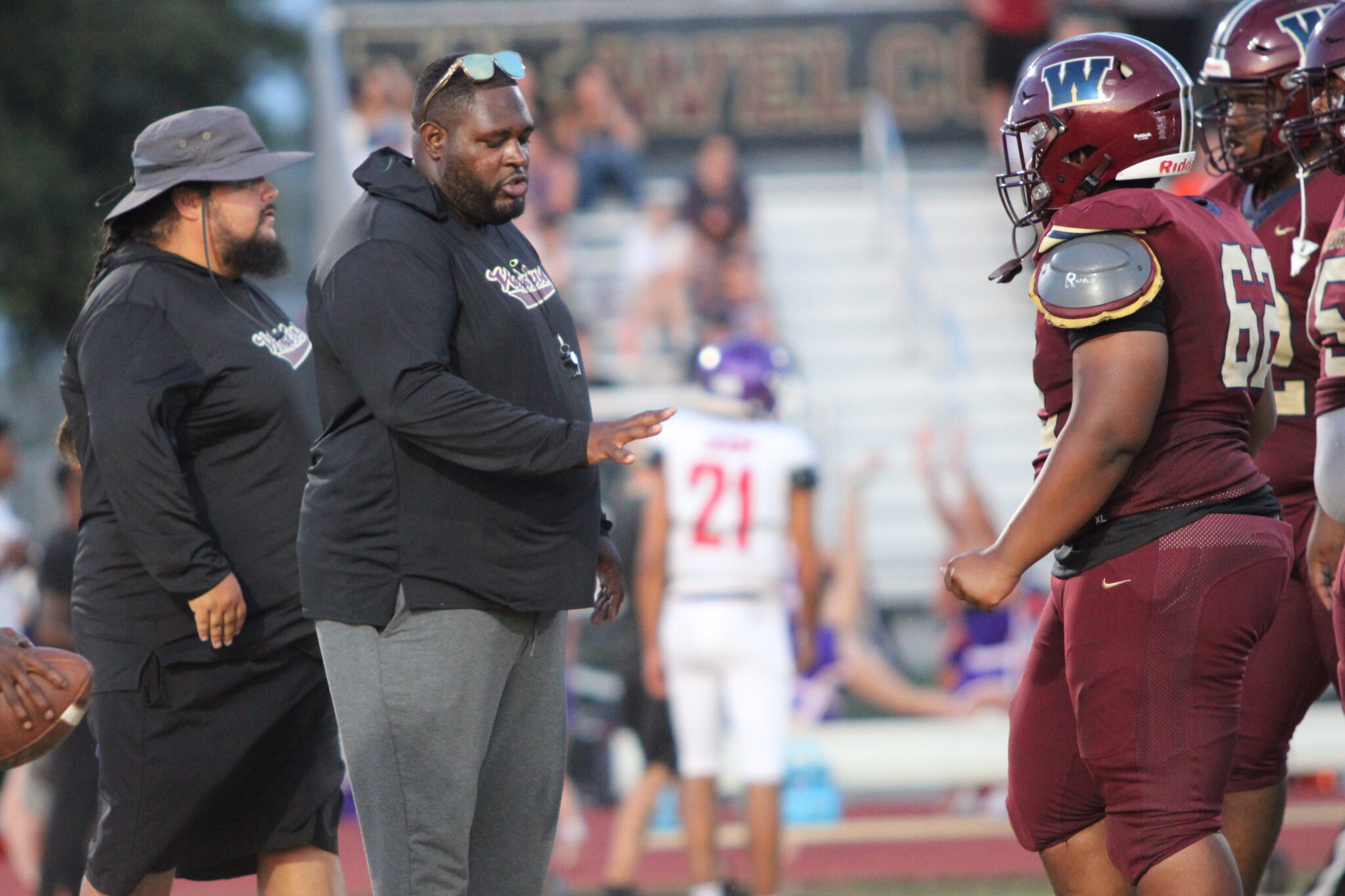 Coach Watts works with his young center Therion Coston in between games.