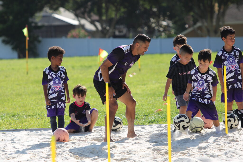 Coach and Club owner Carlos Longa trains the futures program through a dribble drill.