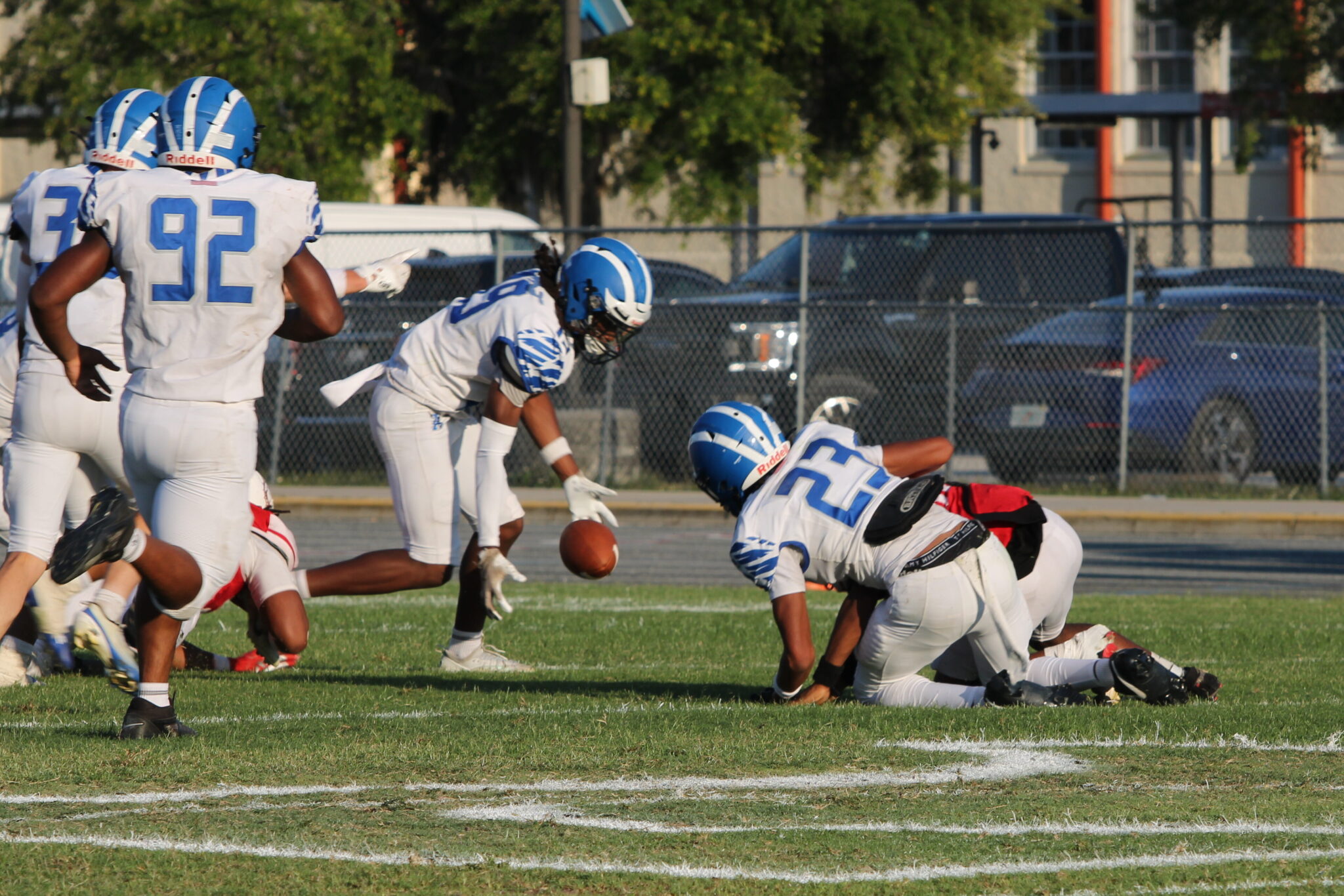 David Wimberly (23) strips the ballcarrier, leaving the ball to be picked up by Ezra Dady (19).