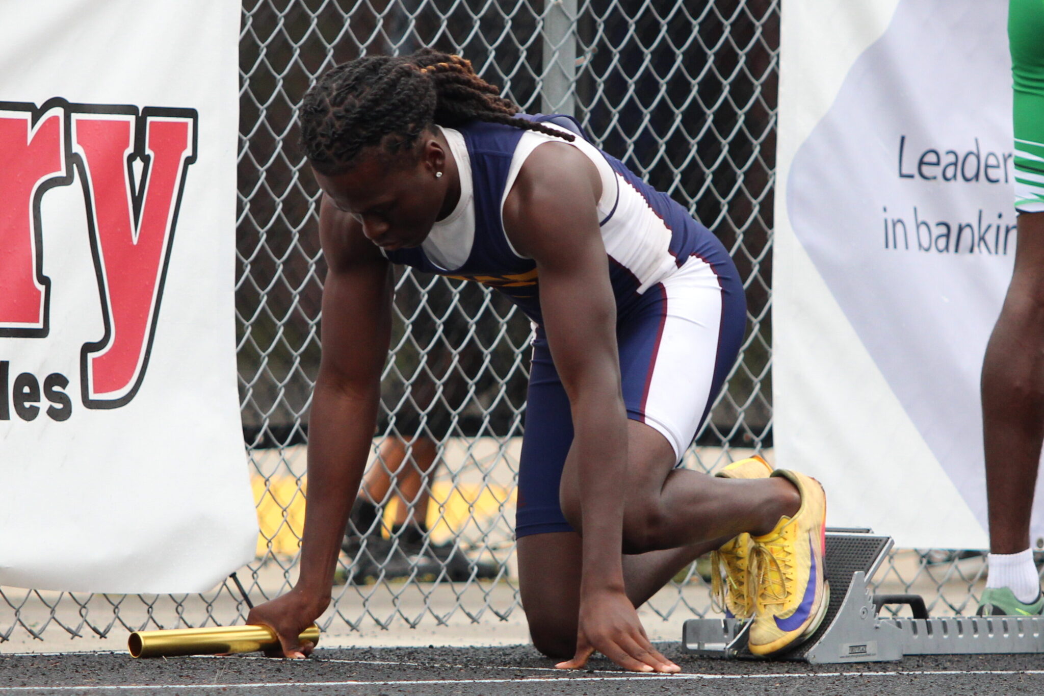 Dominique Walker readies on his block fir the first leg of the boys 4x100m relay